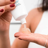 woman pouring CBD Muscle Balm on her palm